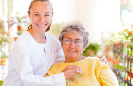 smiling caregiver and old man woman