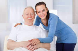 smiling caregiver and old man
